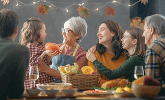 A happy family sitting at the table and celebrating a holiday.